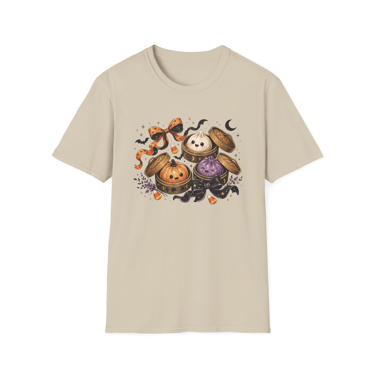 A light beige crewneck t-shirt featuring a colorful graphic print of three cute cartoon cauldrons with faces, surrounded by bats, a witch's hat, and a crescent moon.