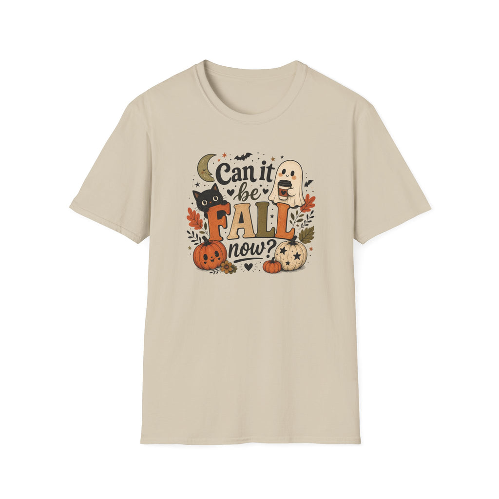 A light beige crewneck t-shirt featuring a colorful graphic print on the front with the text 'Can it be FALL now?' surrounded by autumn and Halloween elements like pumpkins, a ghost, a cat, and leaves.