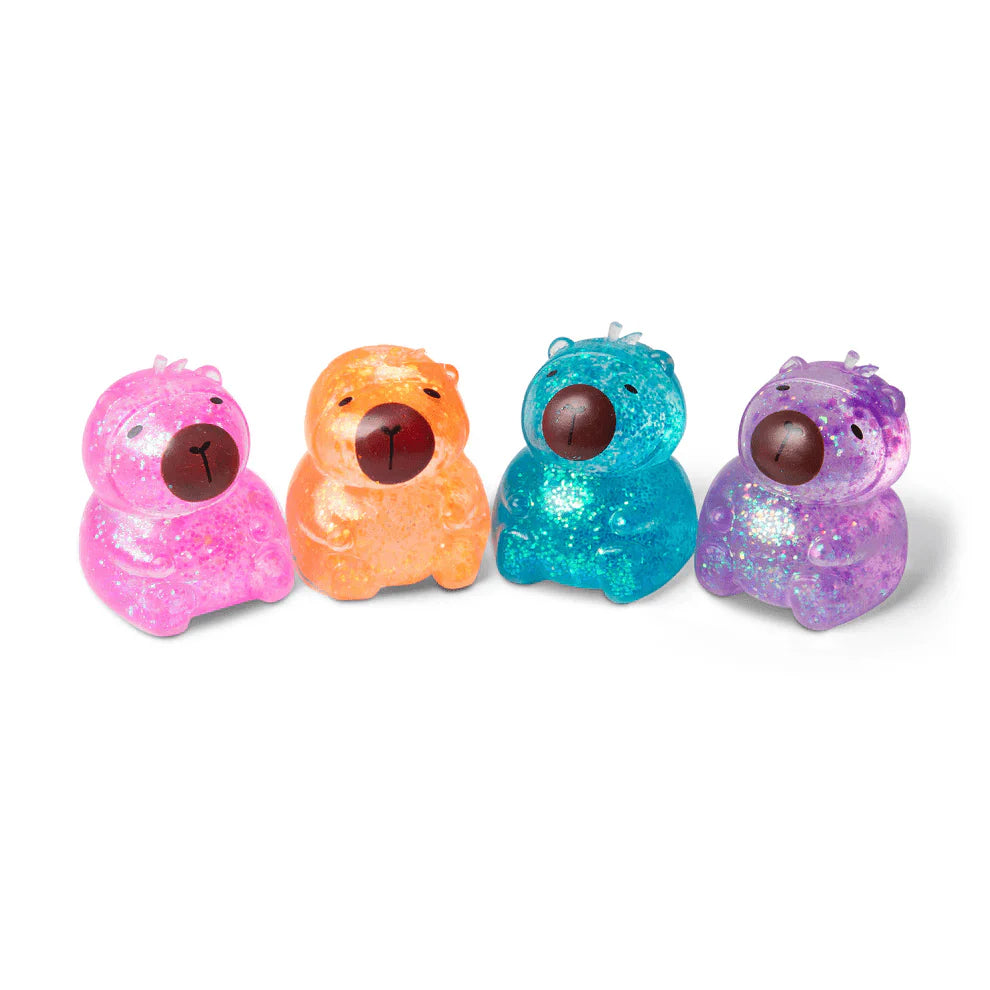 Four small translucent bear-shaped glow-in-the-dark toys in pink, orange, blue, and purple, arranged in a row on a white background.