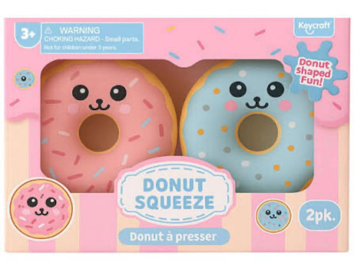 Keycraft Donut Squeeze toy set in its original retail packaging, featuring two cute kawaii donuts with smiling faces: one pink with multicolor sprinkles and one light blue with multicolor dots.