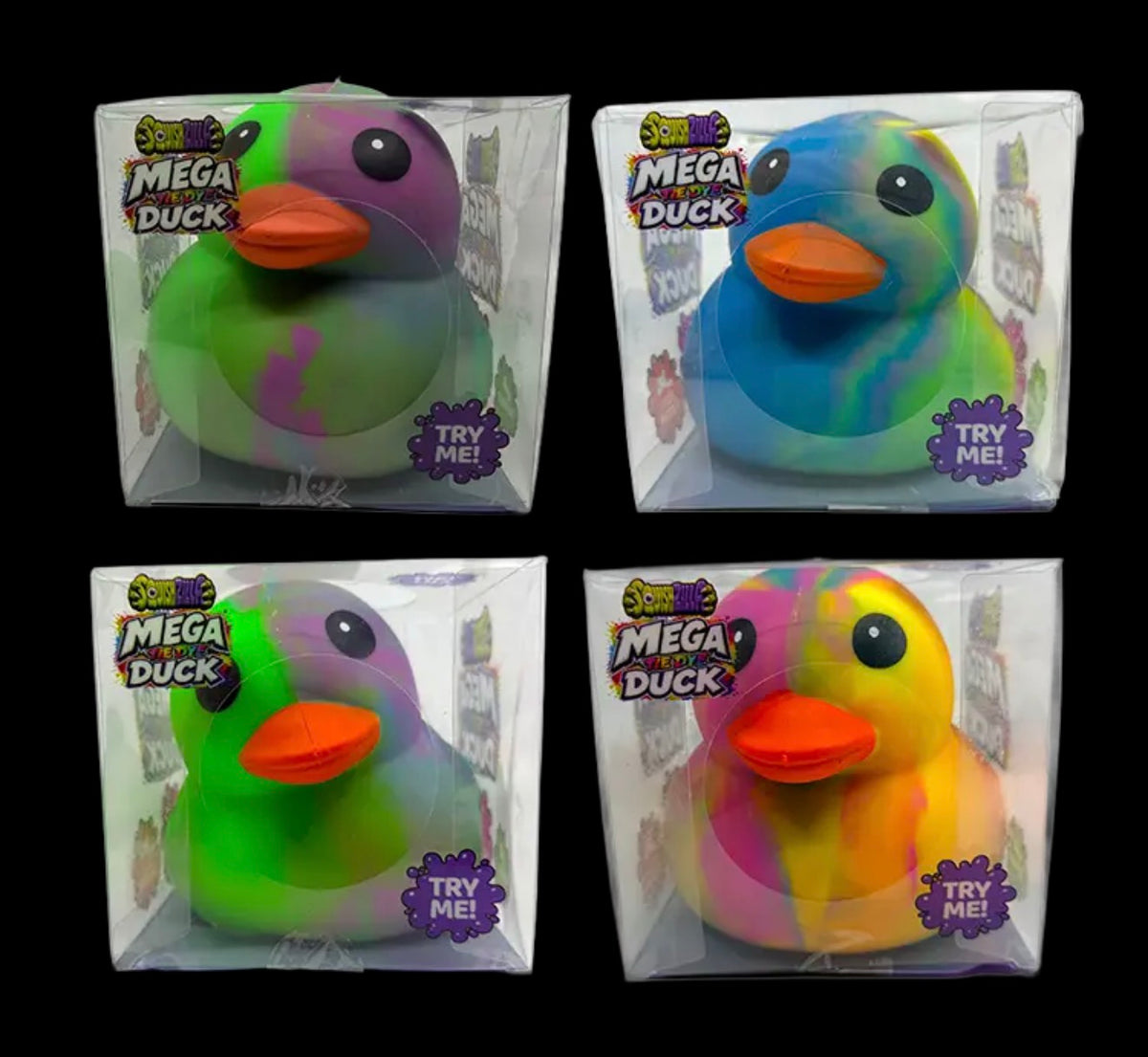 Four Fun Doh SquishZilla Mega Tie-Dye Duck Squishy Toys in clear display boxes, featuring vibrant swirled colors including green, purple, blue, pink, yellow, and orange. These jumbo rubber duck-shaped sensory toys have orange beaks, black eyes, and a soft, squeezable jelly texture.