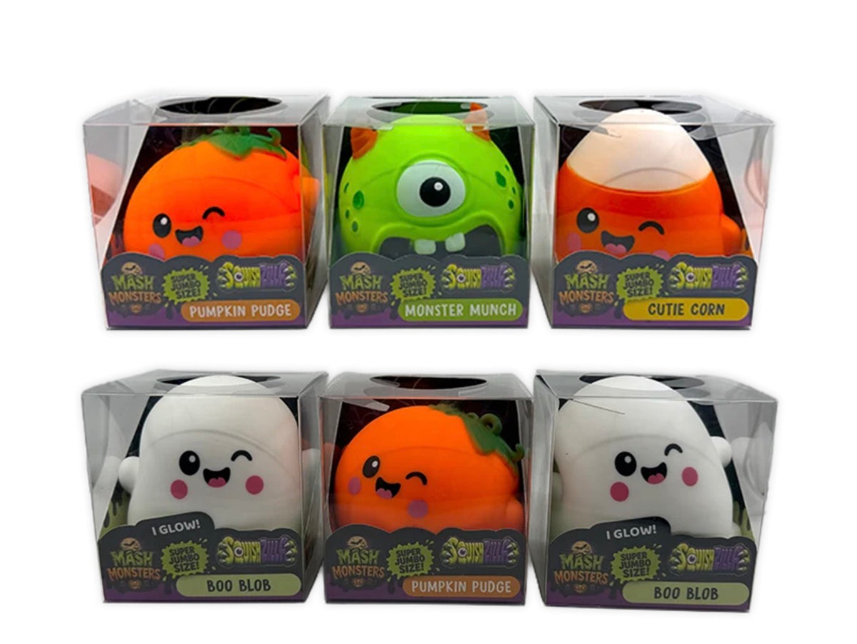 Six packaged squishy plush toys from Mash Monsters, arranged in two rows of three. The characters include Pumpkin Pudge, Monster Munch, Cute Corn, Glow!, Pumpkin Pudge, and Boo Blob, each in a clear plastic box with a branded purple and green label.