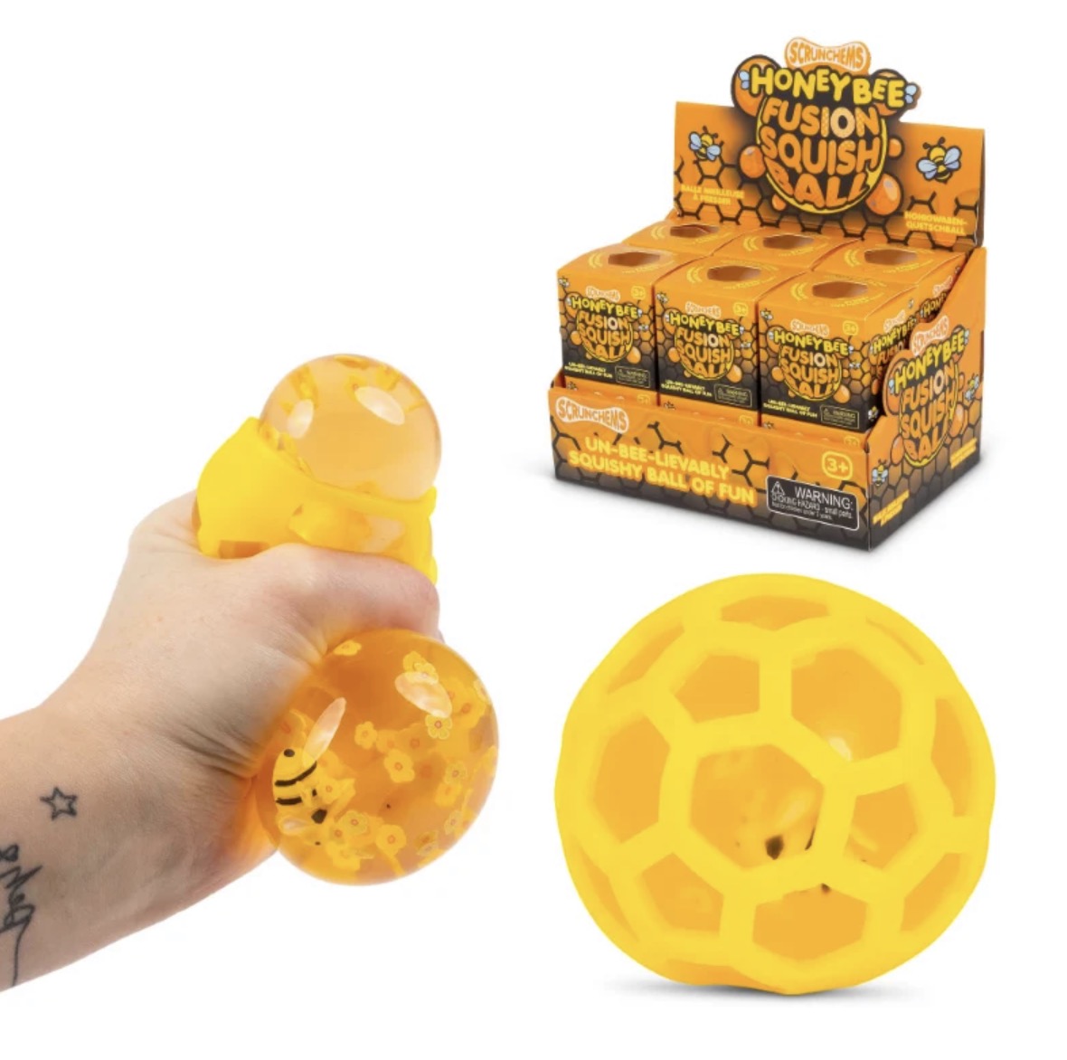 Yellow honeybee fusion quish ball toy shown being squeezed in a hand, a large hollow honeybee-shaped ball, and a retail display box labeled 'Honeybee Fusion Quish Ball' on a white background.