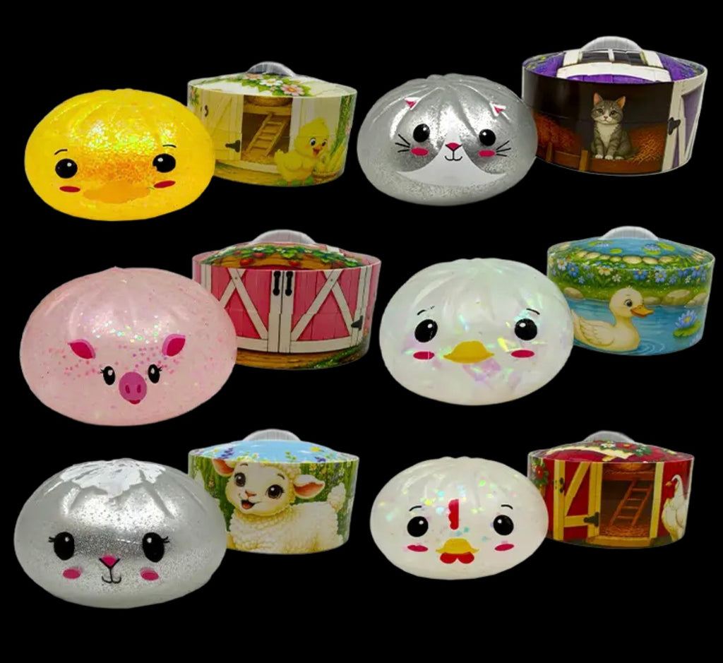 Twelve small round plastic containers with lids, arranged in a 3-by-4 grid on a black background. Each container features a different farm or animal-themed printed design, including yellow chicks, a gray cat, a pink pig, a barn, ducks, and sheep.
