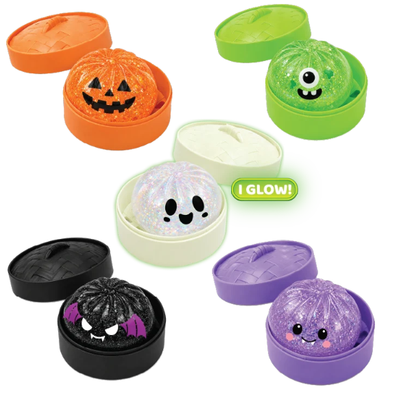 A set of Halloween-themed squishy slime balls in round plastic containers, shown in multiple colors and designs including orange jack-o'-lantern, green one-eyed monster, white glittery ghost, black vampire, and purple pumpkin. One container has a green 'I GLOW!' label.