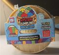 A set of gummy bear mystery dummies in a blue and yellow Crazy Fun branded box, wrapped in clear plastic. The packaging features cartoon gummy bears and text like 'The Original Mystery Dumpling' and 'Gummi Bear Edition'.