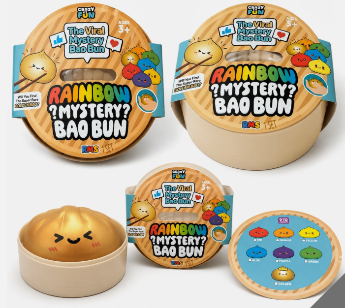 Five packaged toy products from Cosy Fun are arranged on a light gray background. The products include two large round mystery bun packages labeled 'The Vital Mystery Bao Bun' and 'RAINBOW ?MYSTERY? BAO BUN', one smaller round package, one beige bun-shaped toy, and one round blue accessory showing colorful button icons.