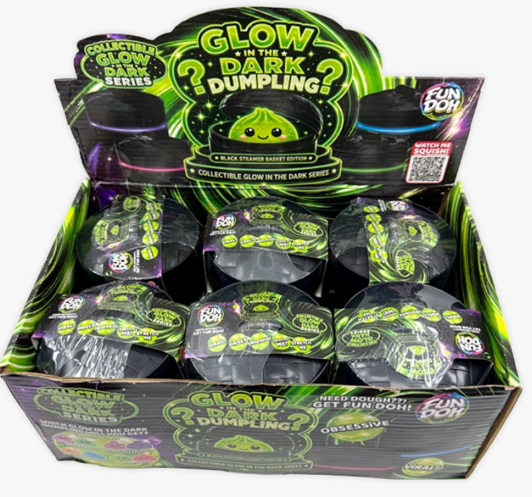 A retail display box filled with multiple sealed 'Glow in the Dark Dumpling' blind packs from Fun Don. The packaging features bright neon green, black, and purple graphics with cartoon dumpling illustrations.