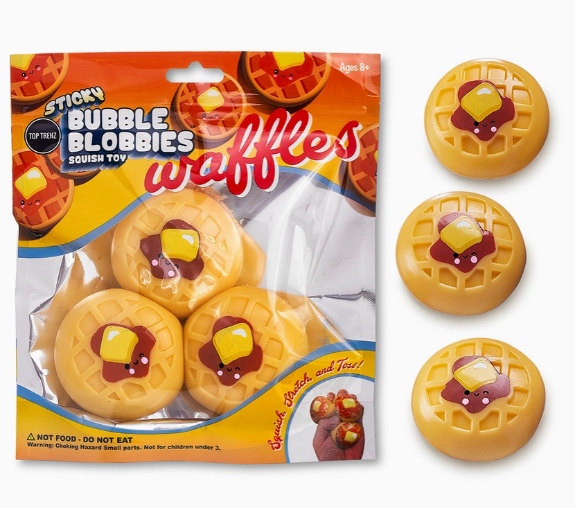 Pack of 'Sticky Bubble Bubbies' waffle squish toys shown in its orange and yellow packaging alongside three individual waffle-shaped toys on a white background.