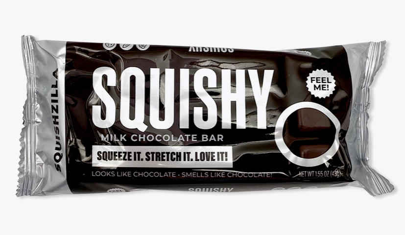 A Squishy Milk Chocolate Bar in its packaging, featuring a dark brown and silver wrapper with white text and a chocolate piece illustration.