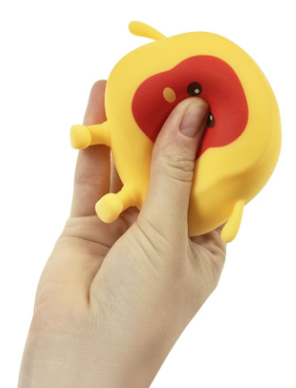 A hand holding a yellow squishy toy shaped like a cartoon toast with a red face and small black eyes, shown against a plain white background.
