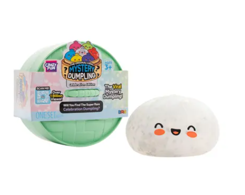 A mystery dumpling toy set showing a light green plastic ball with a colorful 'Mystery Dumpling' package and a white plush dumpling with a smiling face next to it on a white background.