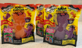 Two packages of Squishy Toy Sour Patch Kids Halloween Edition, one orange and one purple, displayed on a light-colored surface.