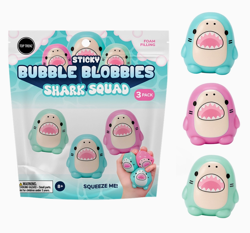 A 3-pack of Sticky Bubble Blobbies Shark Squad squishy toys in their retail packaging, shown alongside three individual shark-shaped toys in mint green, pink, and teal on a white background.
