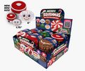 A retail display box of Merry Squishmas mini Christmas dumplings, showing multiple round, squishy candy-like ornaments in red, green, brown, and white holiday designs. The display includes a front panel with product imagery, a QR code, and a 'Special Stepmas' label.
