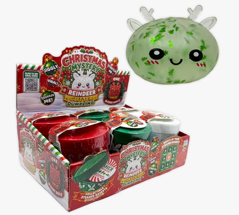 A retail display box of Christmas-themed mystery dump bins alongside a large featured green reindeer-shaped dump bin with glittery green accents and a smiling face.
