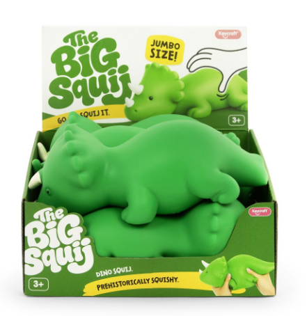 A box of green dinosaur squishy toys, featuring a large Triceratops figure in the center, with packaging that reads 'The Big Squaj' and 'Jumbo Size!'.