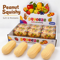 Four beige peanut-shaped squishy toys displayed in front of a branded retail display box labeled 'Peanut Squishy' and 'squeeze soft stretchy'. The box features colorful fruit illustrations and the ASMR logo.