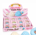 A pink display box labeled 'Squishy Cream Roll' containing 12 small individual boxes of the product, with three large cream and blue squishy rolls shown in the foreground on a white background.