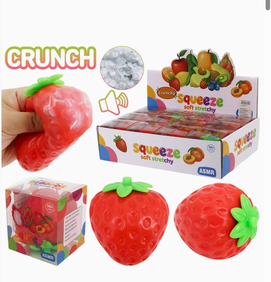 Strawberry-shaped ASMR squishy toys shown with a hand squeezing one, a retail display box, a smaller boxed unit, and two loose toys on a white background. The packaging and text mention 'CRUNCH' and 'squeeze soft stretchy'.