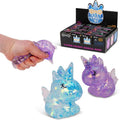 Squishy toy unicorn with glittery texture, held by a hand, displayed against a white background.